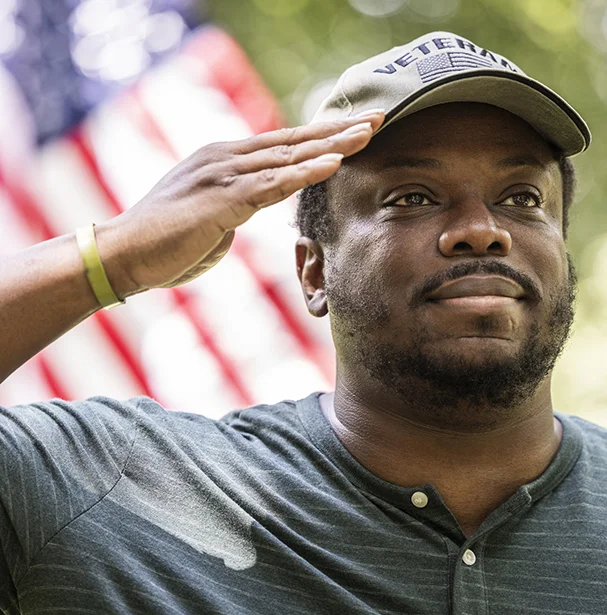 Veteran man doing the patriotic salute with a smile.